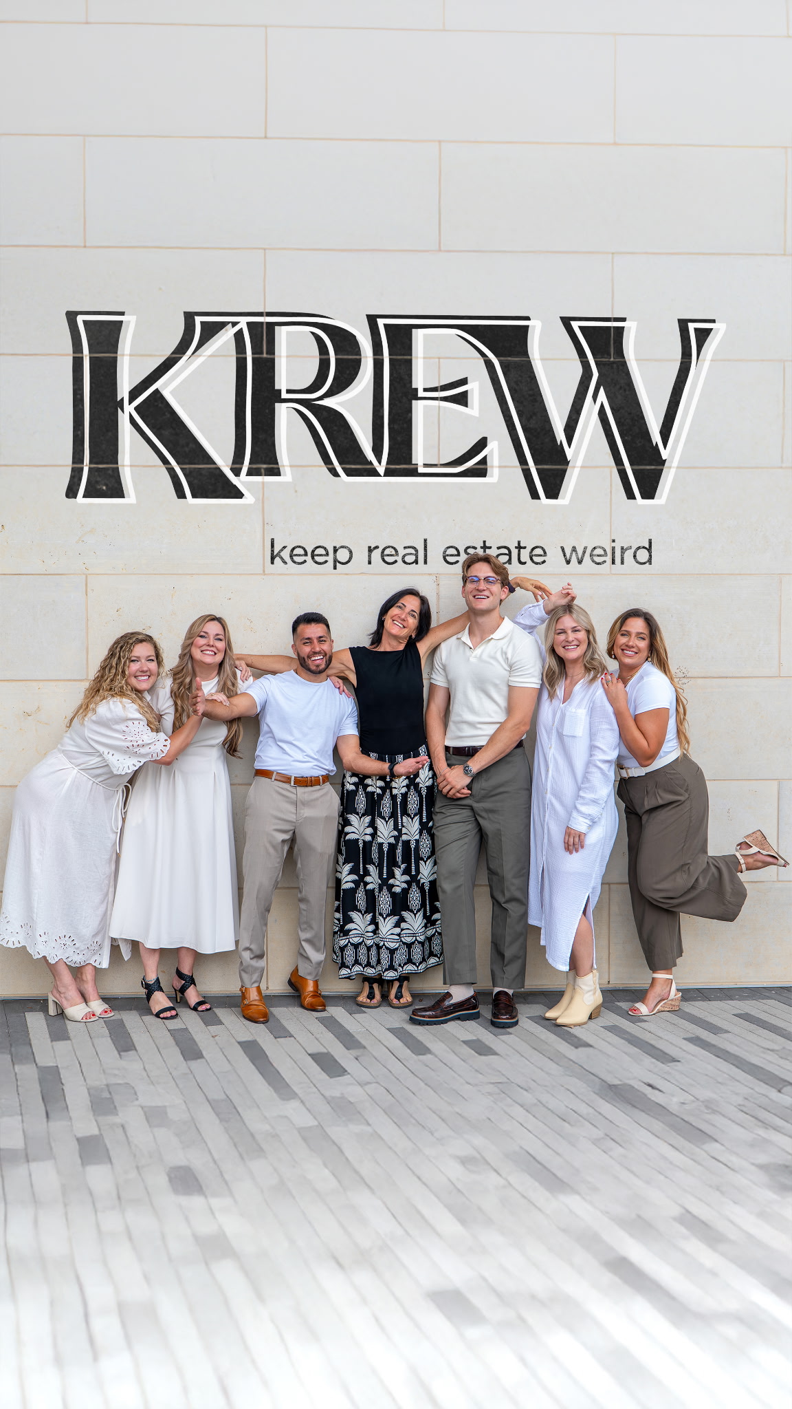 The Krew team together beneath the Keep Real Estate Weird mural